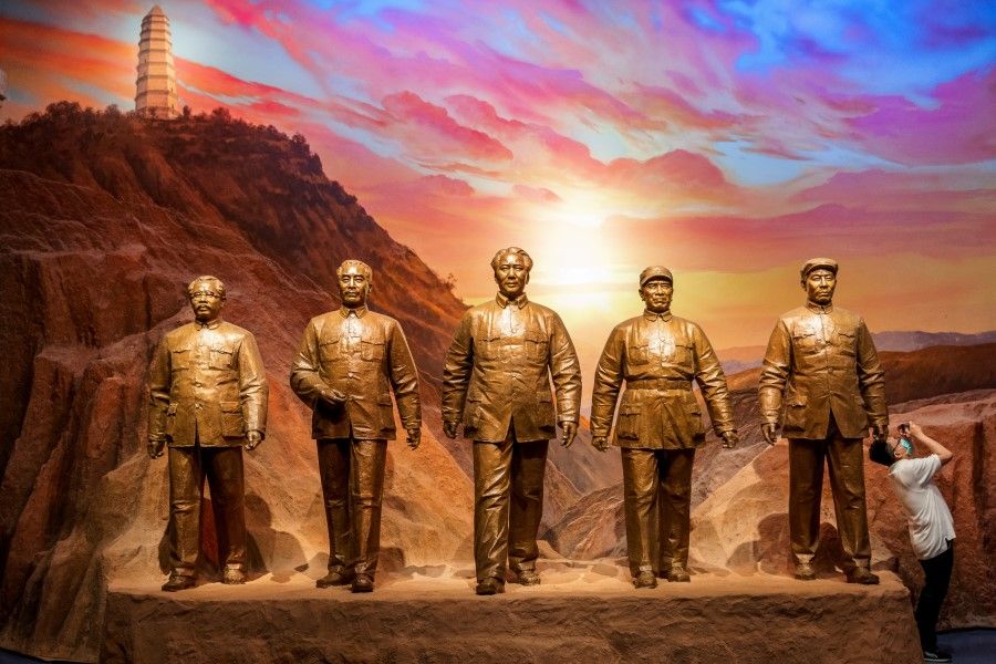 A man takes pictures next to statues of former Chinese Communist leaders Ren Bishi, Zhou Enlai, Mao Zedong, Zhu De and Liu Shaoqi at the Museum of the Communist Party of China that was opened ahead of the 100th founding anniversary of the Party in Beijing, China, 25 June 2021. (Thomas Peter/Reuters)