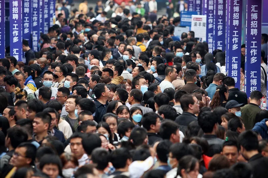 This file photo taken on 11 April 2023 shows people attending a job fair in China's southwestern city of Chongqing. (AFP)