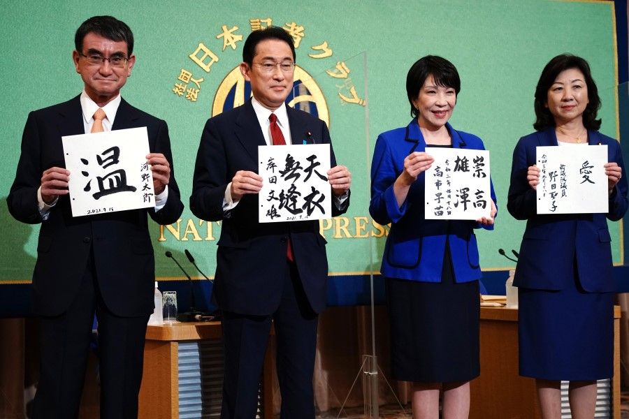 (From left) Taro Kono, Fumio Kishida, Sanae Takaichi and Seiko Noda hold papers with their mottos before a debate ahead of the Liberal Democratic Party (LDP)'s presidential election at the Japan National Press Club in Tokyo, Japan, on 18 September 2021. (Eugene Hoshiko/Bloomberg)