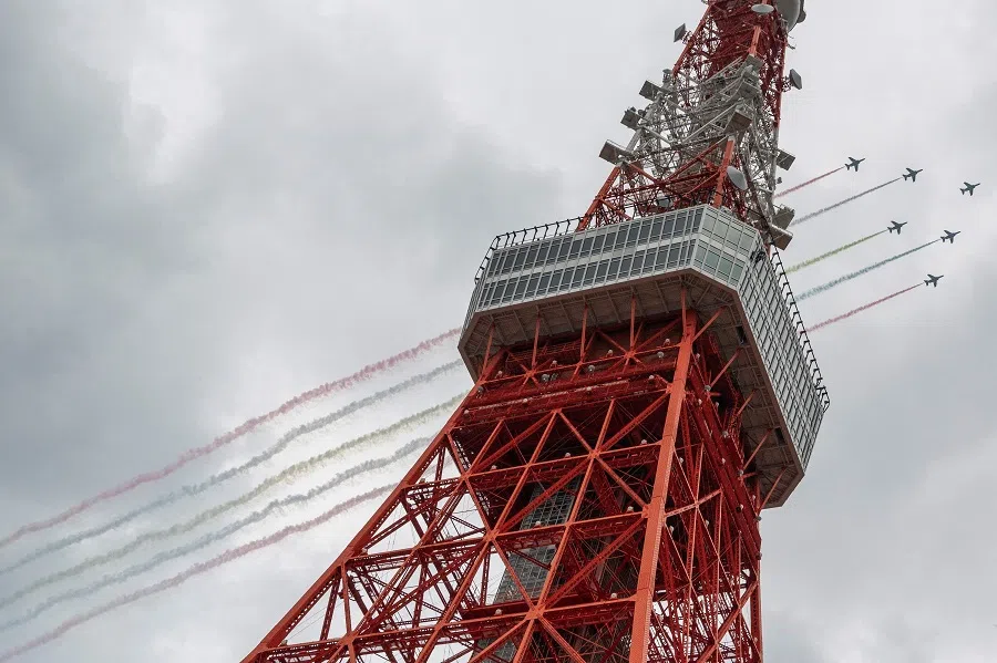 Japan's Air Self-Defense Force (JASDF) aerobatic team Blue Impulse flies over Tokyo Tower on 24 August 2021, ahead of the opening ceremony of the Tokyo 2020 Paralympic Games. (Charly Triballeau/AFP)
