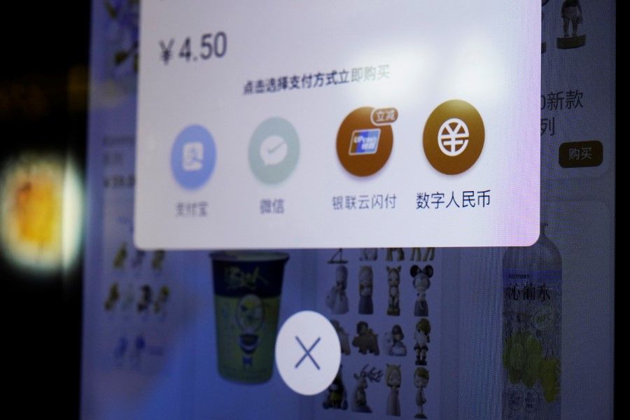 A sign indicating digital yuan, also referred to as e-CNY, is pictured on a vending machine at a subway station in Shanghai, China, 21 April 2021. (Aly Song/Reuters)