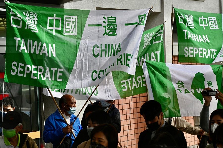 Pro-Taiwan independence activists display banners during a protest before China's Taiwan Affairs officials arrive in Taipei, Taiwan, on 18 February 2023. (Sam Yeh/AFP)