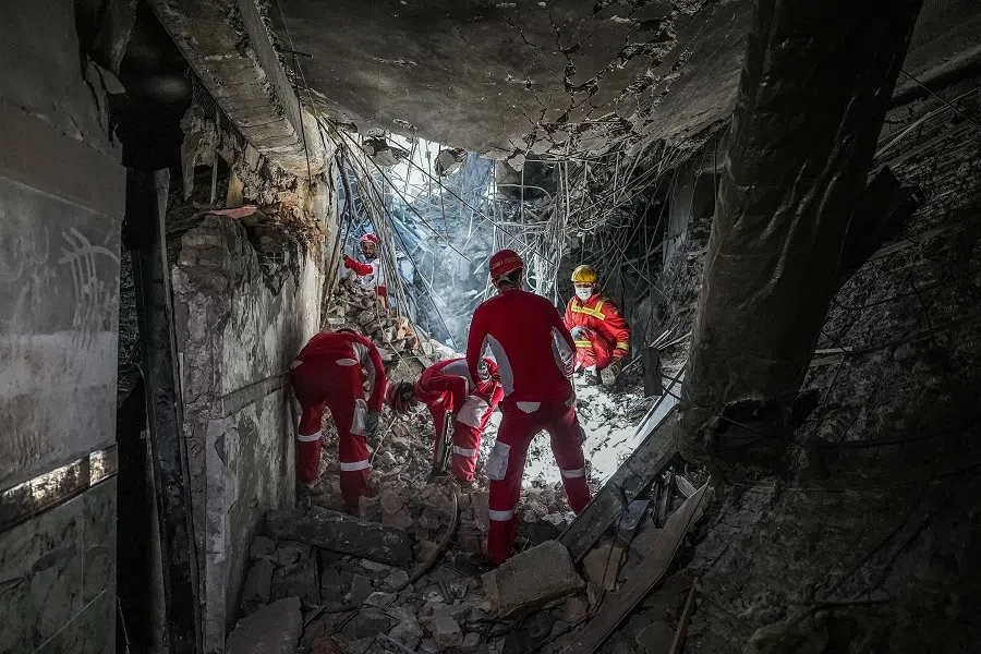 In this picture obtained from the Iranian Mizan News Agency on 25 June 2025, rescuers sift through the rubble inside in the Evin prison complex in Tehran that was hit days ago by an Israeli strike. (Mostafa Roudaki/mizanonline/AFP)