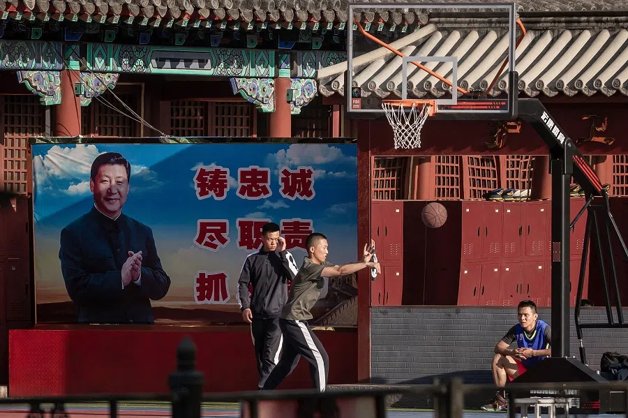 In this file photo taken on 19 May 2020, People's Liberation Army (PLA) soldiers play basketball next to the entrance to the Forbidden City in Beijing, China. (Nicolas Asfouri/AFP)
