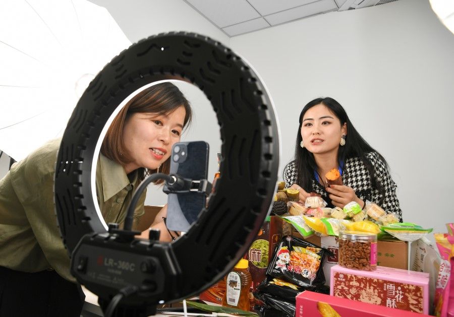 Two women participate in a livestreaming e-commerce contest in Anhui, China, 19 October 2021. (CNS)