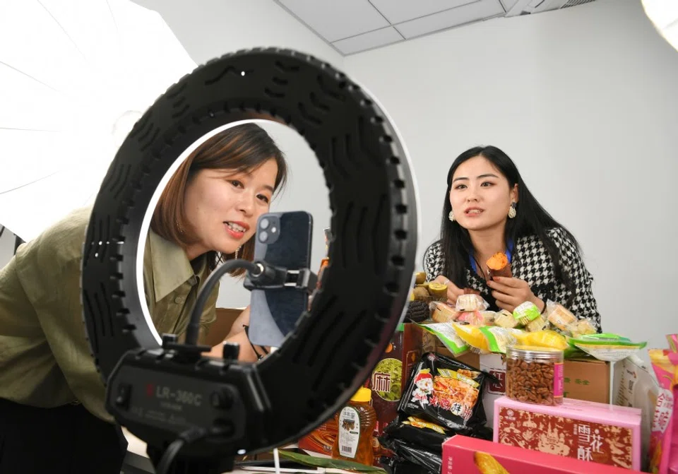 Two women participate in a livestreaming e-commerce contest in Anhui, China, 19 October 2021. (CNS)