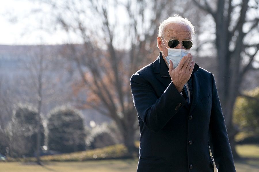 US President Joe Biden wears a protective mask while speaking to members of the media on the South Lawn of the White House after arriving on Marine One in Washington, DC, US, on 8 February 2021. (Stefani Reynolds/Bloomberg)