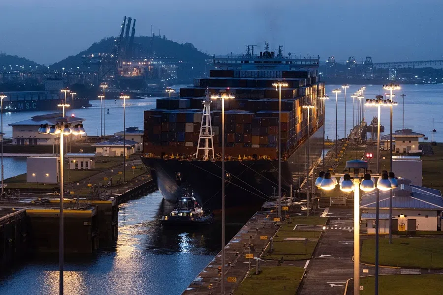 A tug guides a container ship through the Cocoli Locks at the Panama Canal in Panama City, Panama, on 21 February 2025.