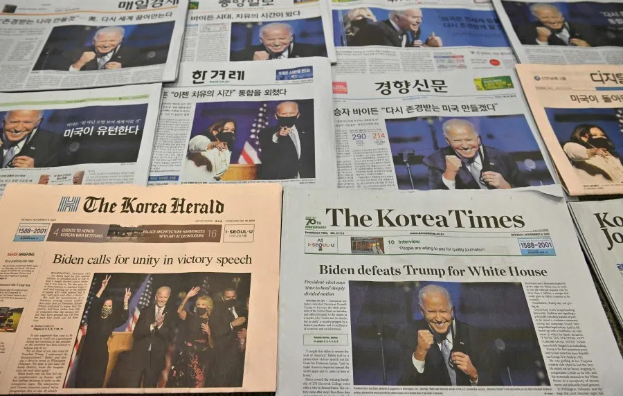 This photo illustration taken in Seoul on 9 November 2020 shows the front pages of South Korea's newspapers carrying stories and pictures of US President-elect Joe Biden. (Jung Yeon-je/AFP)
