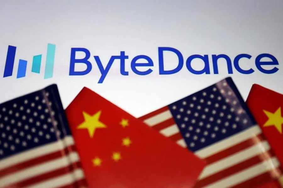 Flags of China and U.S. are seen near the logo of TikTok owner ByteDance logo in this illustration picture taken 18 September 2020. (Florence Lo/Illustration/Reuters)