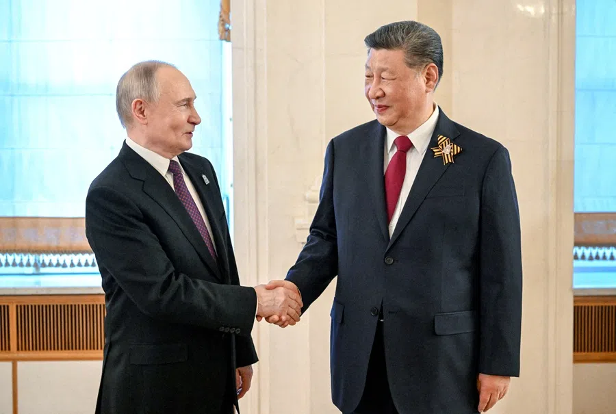 Russian President Vladimir Putin shakes hands with Chinese President Xi Jinping before a festive concert, held on the occasion of the 80th anniversary of the victory over Nazi Germany in World War Two, in Moscow, Russia, on 8 May 2025. (Sergei Bobylyov/Host agency RIA Novosti/Handout via Reuters)