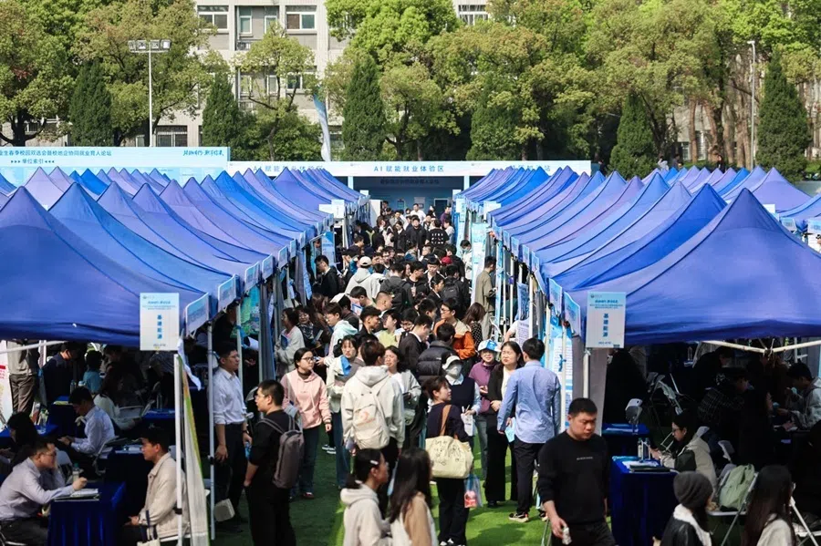 Wuhan University students at a career fair, including companies such as Huawei, Xiaomi and Unitree Robotics, March 2026.