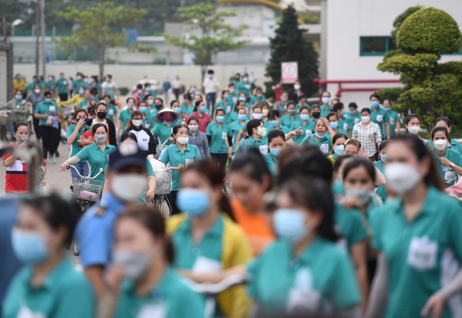 This picture taken on 30 November 2022 shows workers leaving their workplace at Taiwanese Ty Hung factory in Ho Chi Minh City. (Nhac Nguyen/AFP)