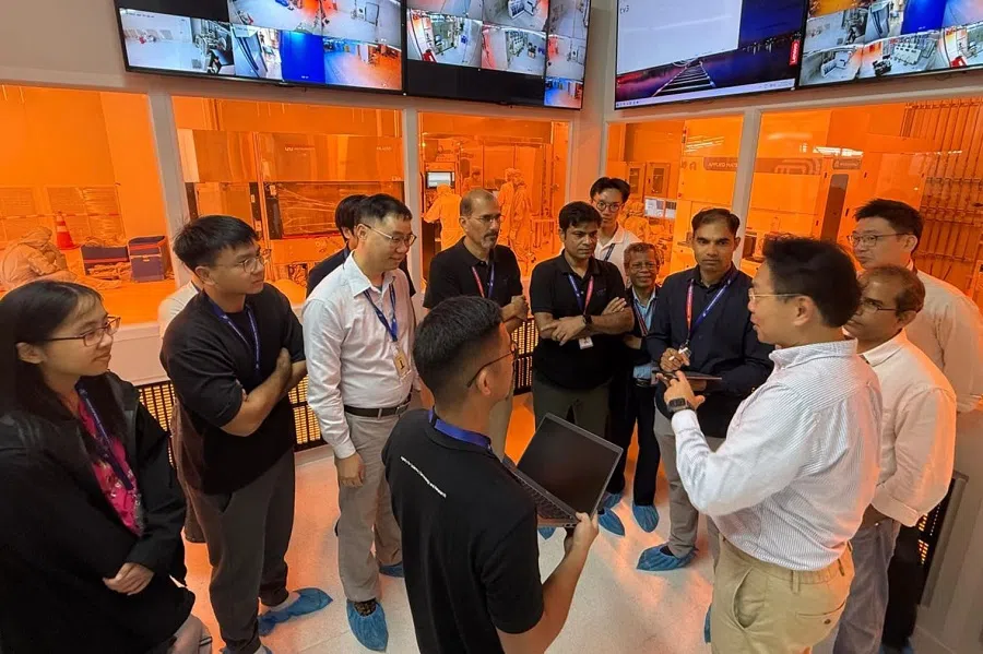 Prof Yeo (right) at a briefing with A*STAR researchers and interns. (Photo provided by interviewee)