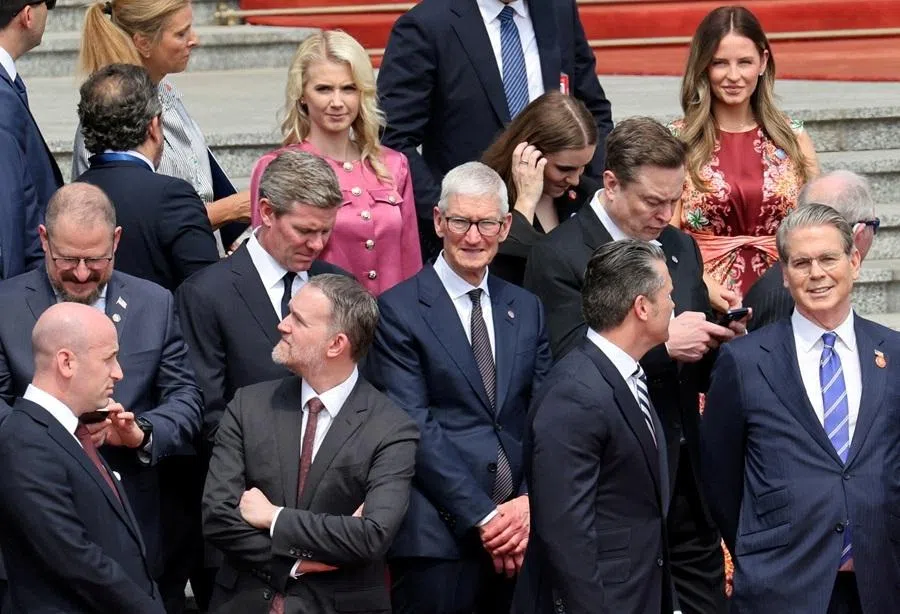US Treasury Secretary Scott Bessent, Defense Secretary Pete Hegseth, Trade Representative Jamieson Greer, White House Deputy Chief of Staff Stephen Miller, Tesla CEO Elon Musk, Apple CEO Tim Cook and other members of the US delegation stand before the welcome ceremony for US President Donald Trump, at the Great Hall of the People in Beijing, China, 14 May 2026.