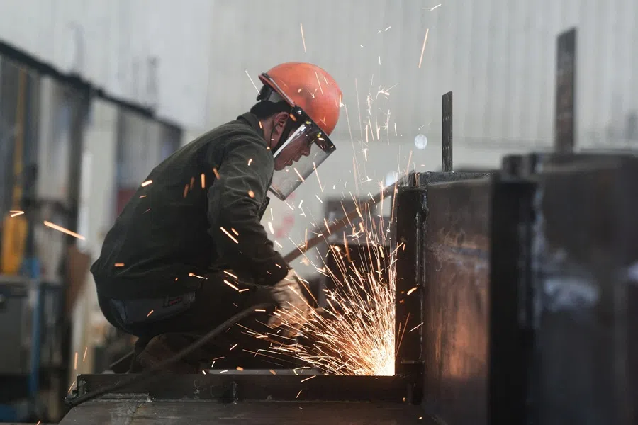 An employee works at a factory which produces steel structures in Hangzhou, in China’s eastern Zhejiang province on 15 July 2025. (AFP)