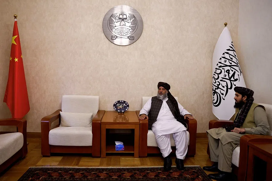 Haji Nooruddin Azizi, the Taliban’s acting commerce minister, sits next to flags of the Islamic Emirate of Afghanistan and China, during an interview with Reuters, at the embassy of Afghanistan in Beijing, China, on 19 October 2023. (Tingshu Wang/Reuters)