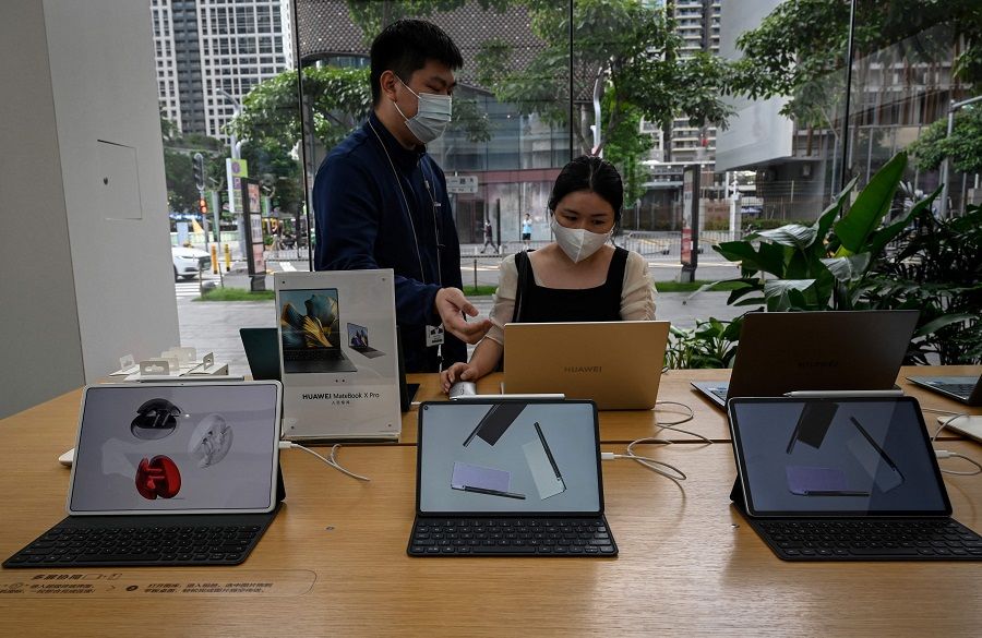 This photo taken on 8 July 2022 shows customers trying Huawei products at the company's flagship store in Shenzhen, Guangdong province, China. (Jade Gao/AFP)