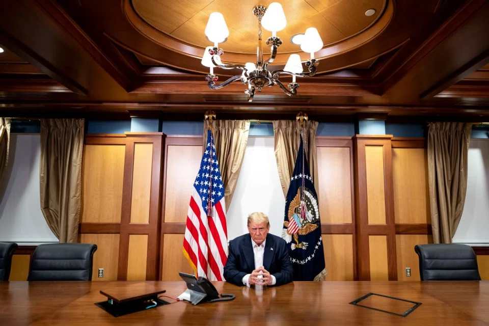 US President Donald Trump participates in a phone call with Vice President Mike Pence, Secretary of State Mike Pompeo, and Chairman of the Joint Chiefs of Staff Gen. Mark Milley, 4 October 2020, in his conference room at Walter Reed National Military Medical Center in Bethesda, Maryland. (Tia Dufour/The White House/Handout via REUTERS)