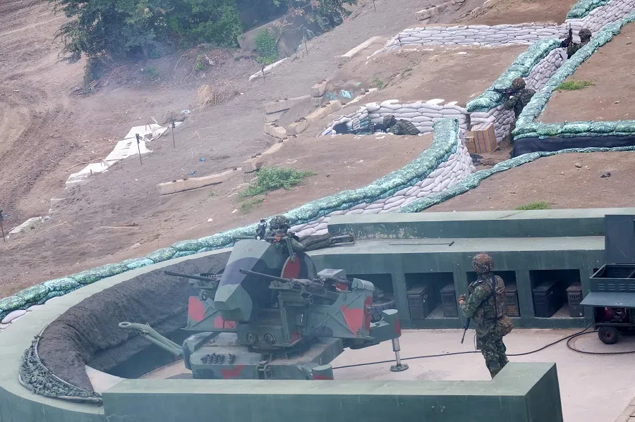 Taiwan military soldiers stand guard at the trenches during the annual Han Kuang anti-landing drill at Bali beach, New Taipei City, Taiwan on 27 July 2023. (Sam Yeh/AFP)