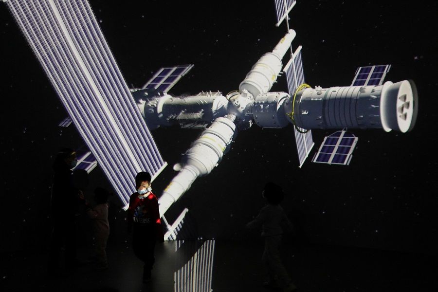 A child stands near a giant screen showing the image of the Tianhe space station on the country's Space Day at China Science and Technology Museum in Beijing, China, 24 April 2021. (Tingshu Wang/File Photo/Reuters)