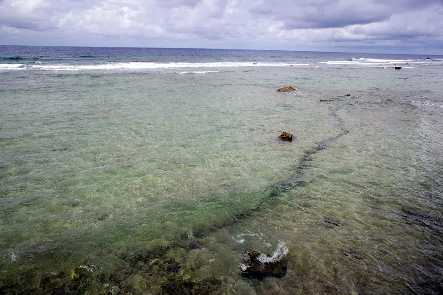 This file photo taken on 13 February 2014 shows a rift in the reef of the Mururoa, an atoll in French Polynesia, where French forces have conducted nuclear weapon tests until 1996, in Mururoa, southern Pacific ocean. (Gregory Boissy/AFP)