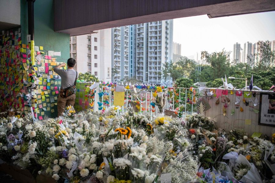 A makeshift memorial overflowing with flowers is seen at the car park where student Alex Chow, 22, fell during a recent protest in the Tseung Kwan O area on the Kowloon side of Hong Kong on November 9, 2019. (Laurel Chor/AFP)