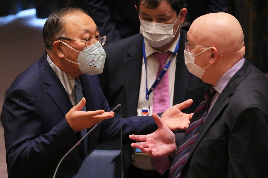 Zhang Jun, China's Permanent Representative to the UN, and his Russian counterpart Ambassador Vasily Nebenzia speak before the start of a meeting to discuss the humanitarian crisis in Ukraine at the United Nations headquarters on 7 March 2022 in New York. (Michael M. Santiago/Getty Images/AFP)