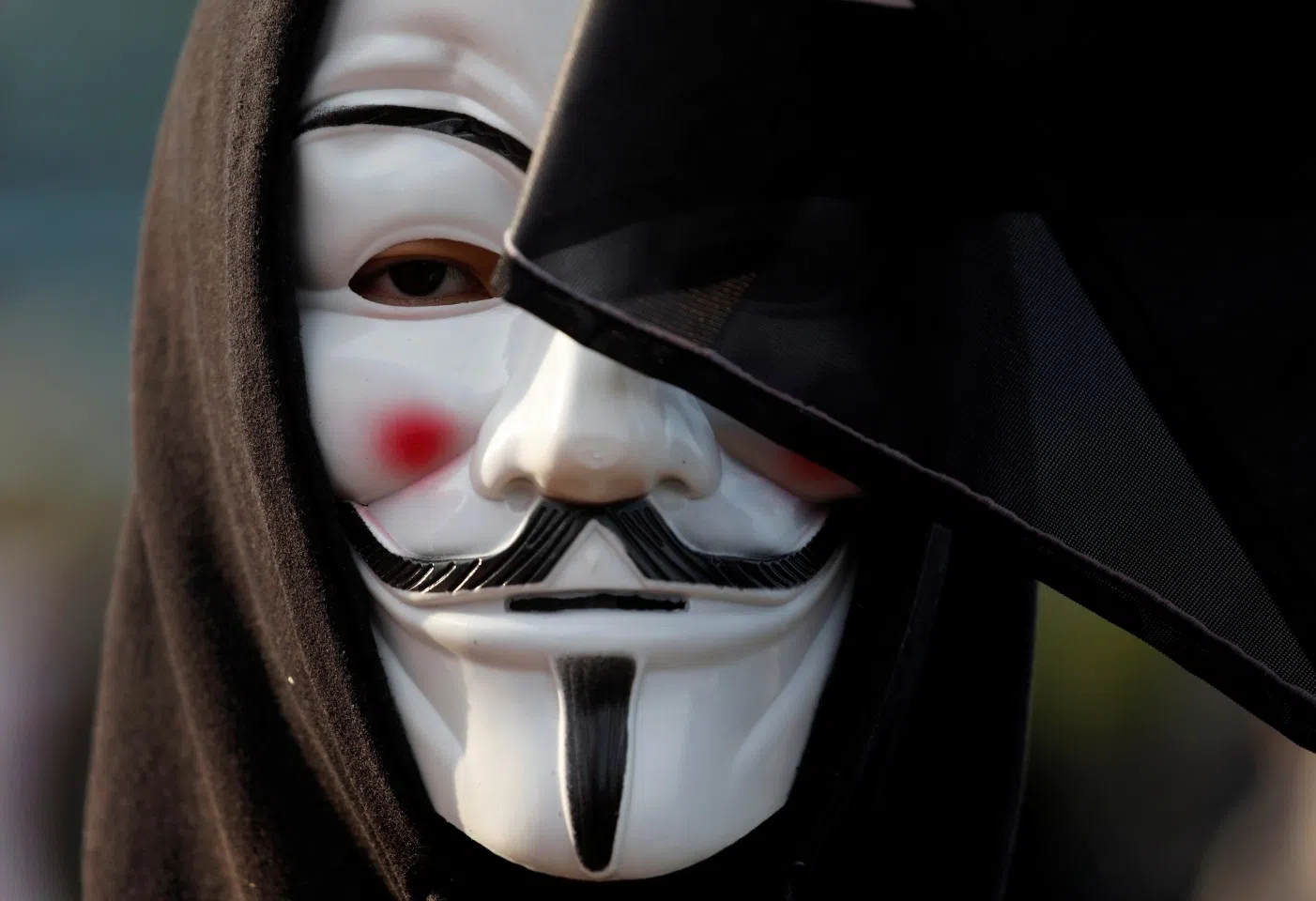 An anti-government demonstrator wearing a Guy Fawkes mask takes part in a protest at Edinburgh Place in Hong Kong on 12 January 2020. (Navesh Chitrakar/Reuters)