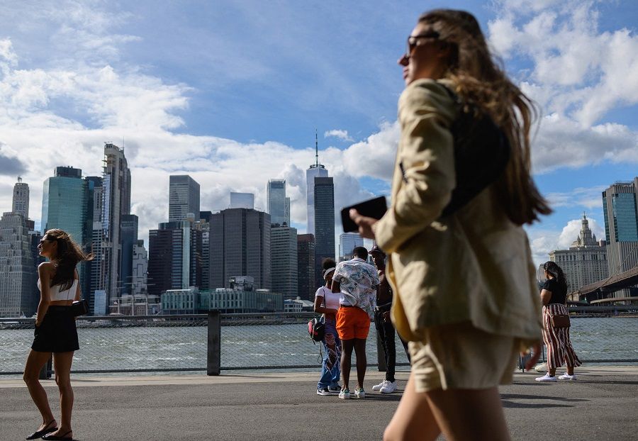People walk at Brooklyn Bridge Park in New York City, US on 19 August 2021. (Angela Weiss/AFP)