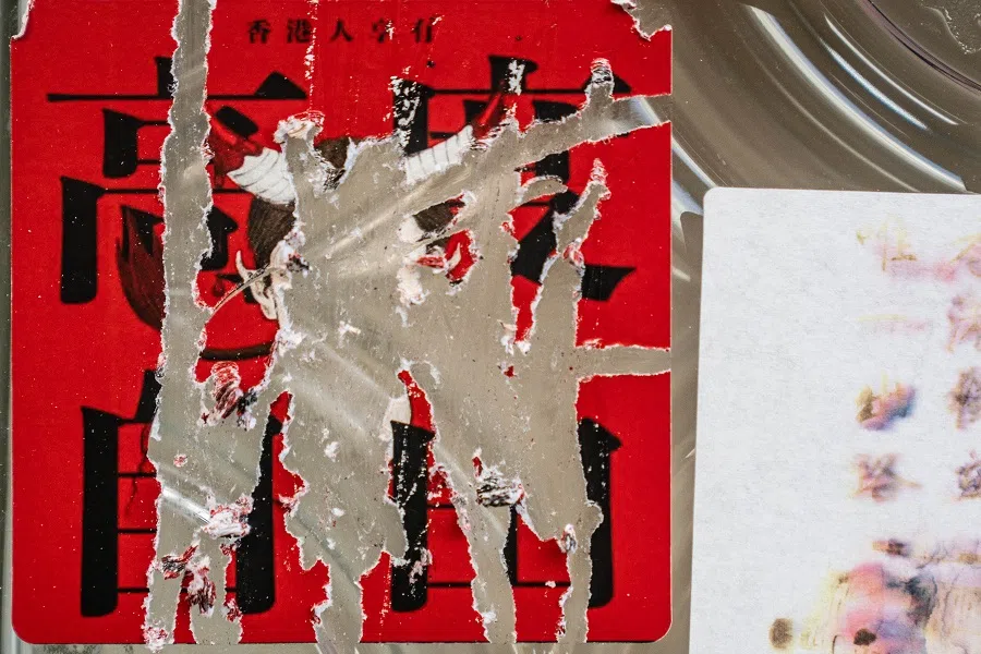 A sign reading "Hong Kong People Enjoy a High Degree of Freedom" is still visible behind messages supporting the pro-democracy movement that have been scraped off. (Lam Yik/Bloomberg)