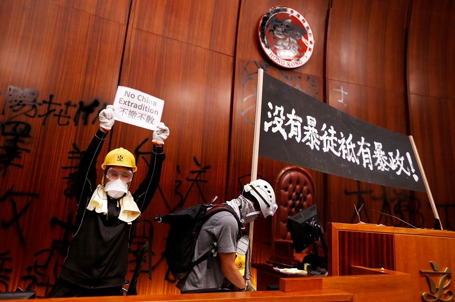 Protesters breaking into the Legislative Council building on the anniversary of Hong Kong's handover to China in Hong Kong in July 2019. The banner reads "There are no thugs, only tyranny". (Reuters/file photo)