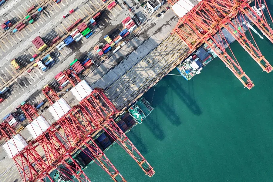 Shipping containers and gantry cranes are seen at a port in Lianyungang, in eastern China’s Jiangsu province, 7 August 2024. (AFP)