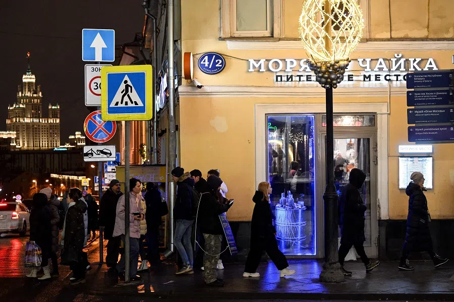 People walk on a street with shops and restaurants in central Moscow, Russia, on 4 February 2023. (Kirill Kudryavtsev/AFP)