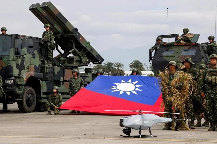 Taiwanese soldiers pose with a Taiwanese flag near a Sky Sword II surface-to-air missile launcher and a military UAV during an annual military exercise in Taichung, Taiwan, on 27 January 2026. (Ann Wang/Reuters)