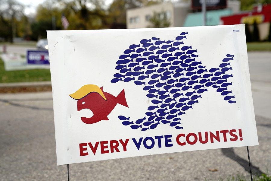 A sign encouraging voter turnout is seen at a campaign yard sign distribution site in Madison, Wisconsin, US, 17 October 2020. (Bing Guan/File Photo/Reuters)