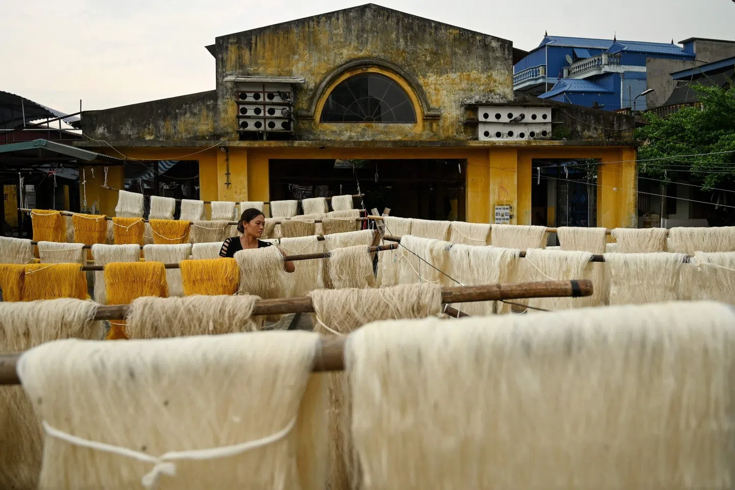 Textile and apparel production are two of Vietnam's biggest industries (in terms of export). This photo shows a worker drying collected silk thread yarns in an open courtyard in Co Chat village in Vietnam's Nam Dinh province on September 17, 2019. (Manan Vatsyayana/AFP)