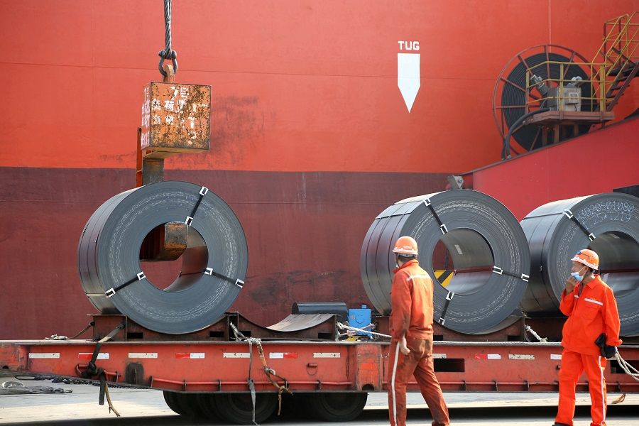 Workers load steel products for export to a cargo ship at a port in Lianyungang, Jiangsu province, China, 27 May 2020. (China Daily via Reuters)