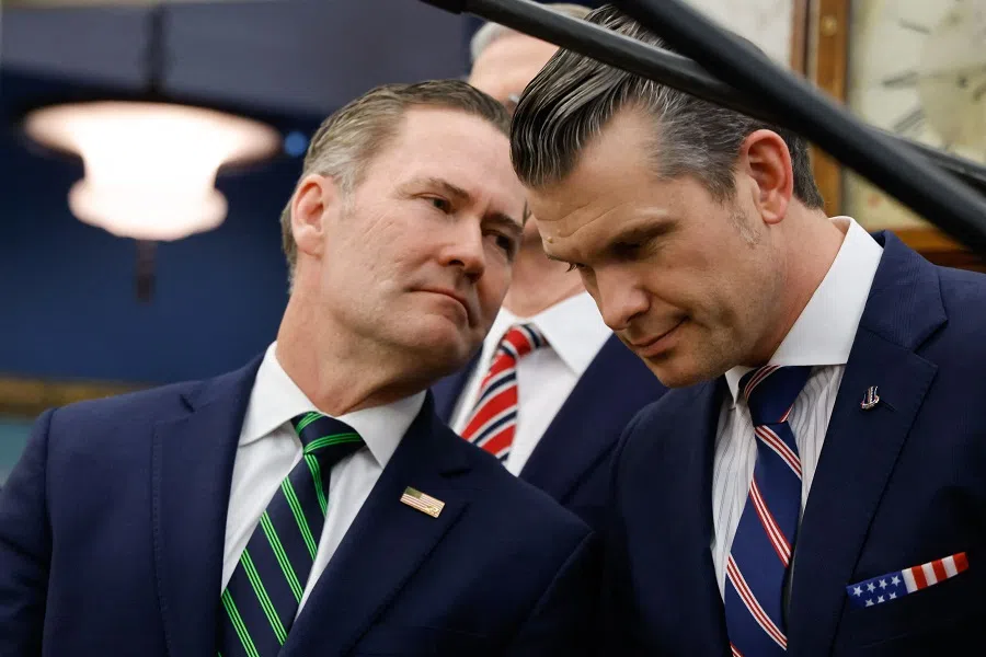 US national security adviser Mike Waltz (left) speaks with Defence Secretary Pete Hegseth as US President Donald Trump meets with French President Emmanuel Macron in the Oval Office of the White House in Washington, DC, on 24 February 2025. Waltz is to leave his post following a scandal in which a journalist was accidentally included on a chat between officials about air strikes on Yemen, US media reported 1 May 2025. (Ludovic Marin/AFP)