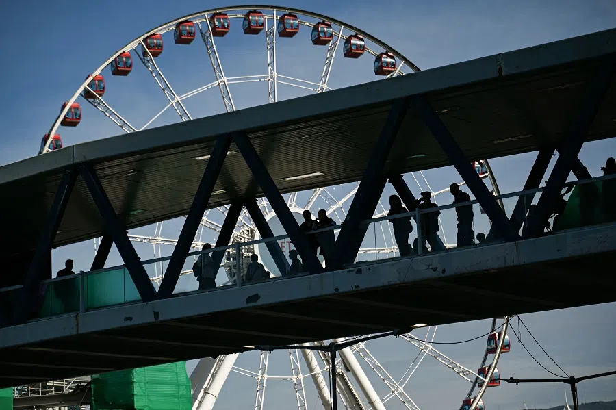 People walk on an overpass in the central business district of Hong Kong on 10 December 2024. (Peter Parks/AFP)