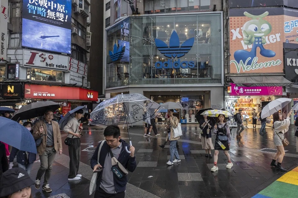Pedestrians walk down a shopping street in Taipei, Taiwan, on 6 December 2023. (Lam Yik Fei/Bloomberg)