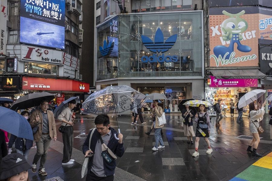 Pedestrians walk down a shopping street in Taipei, Taiwan, on 6 December 2023. (Lam Yik Fei/Bloomberg)