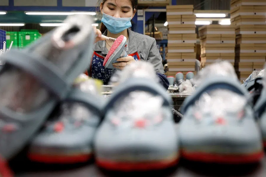 An employee works at a shoe factory for export in Hanoi, Vietnam, on 29 December 2020. (Kham/Reuters)