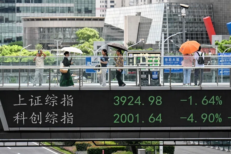 A footbridge with a screen displaying the Shanghai composite index (up) is seen in the financial district of Shanghai on 19 August 2026.
