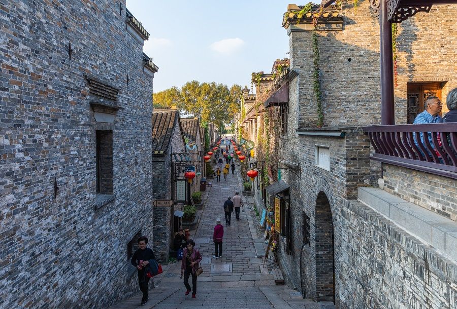 People walk along an alley in Zhenjiang Xijin Ferry site, said to be the birthplace of Zhenjiang ham jelly. (iStock)