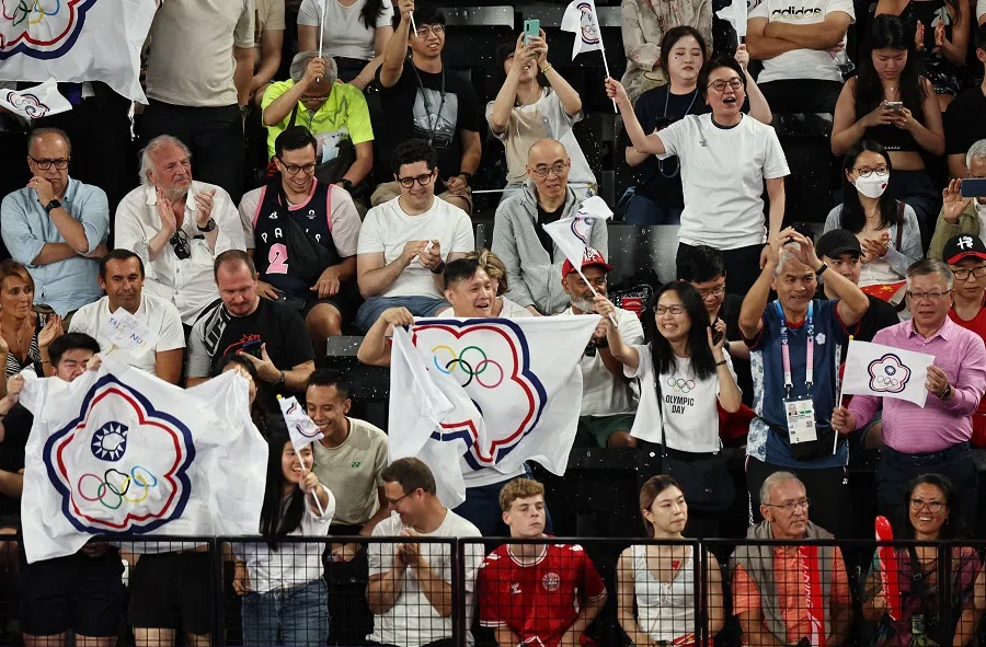 Supporters holding the Chinese Taipei Olympic flags in the stands during the men’s doubles badminton gold medal match at the Paris 2024 Olympics on 4 August 2024. (Hamad I Mohammed/Reuters)