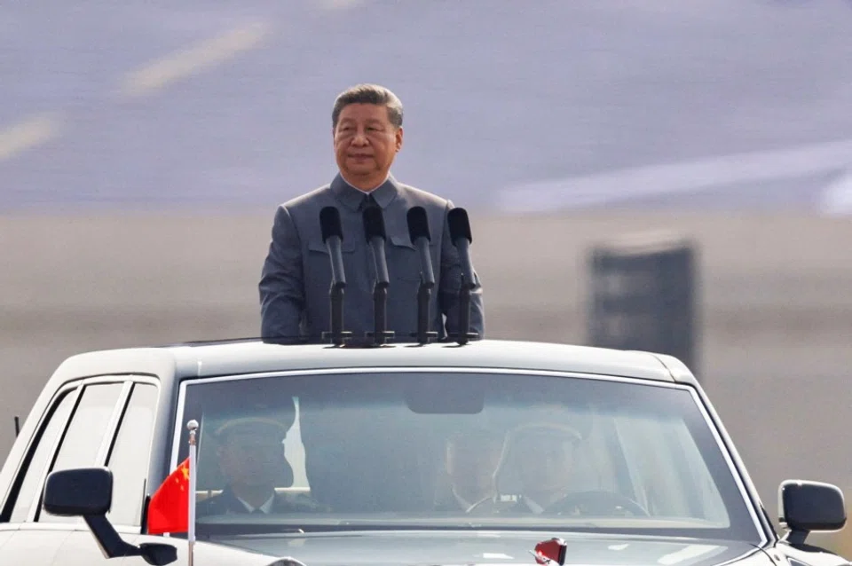 Chinese President Xi Jinping stands in a car to review the troops during a military parade to mark the 80th anniversary of the end of World War II, in Beijing, China, on 3 September 2025. (Tingshu Wang/Reuters)