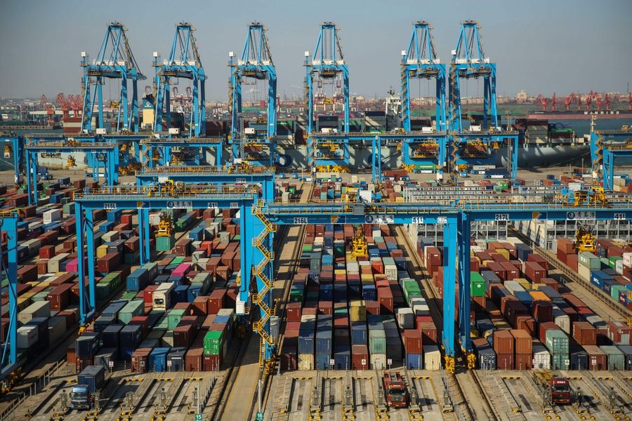 China's economic miracle has transformed a poor country into the second largest economy in the world. This file photo taken on November 28, 2019 shows containers stacked up at an automatic dock in Qingdao in China's eastern Shandong province. (STR/AFP)