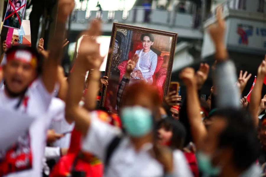 Protesters hold up a portrait of Aung San Suu Kyi and raise three-finger salutes, during a demonstration to mark the second anniversary of Myanmar's 2021 military coup, outside the Embassy of Myanmar in Bangkok, Thailand, 1 February 2023. (Athit Perawongmetha/Reuters)