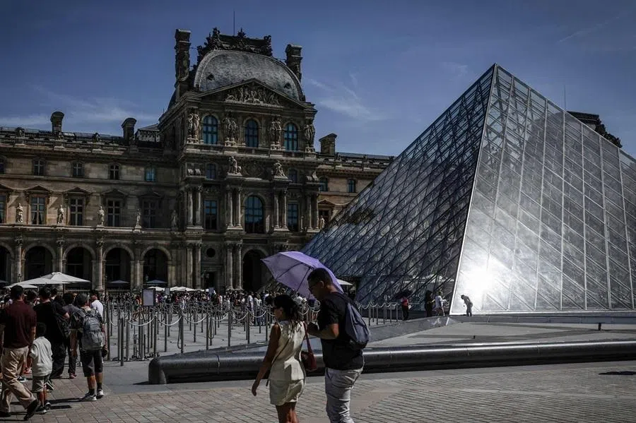Tourists queue at the Louvre Museum in Paris on 28 May 2026.